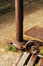 Abstract detail of bench, lamp-post and manhole, all rusty, on the sidewalk - pavement Royalty Free Stock Photo