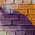 Abstract detail of brick wall with fragment of violet and orange graffiti. Urban Art close-up, for background use Royalty Free Stock Photo