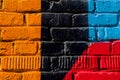 Abstract detail of brick wall with fragment of colorful graffiti. Urban Art closeup. Concept of Modern iconic urban Royalty Free Stock Photo