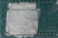 Abstract, detail of an old, mint green, wooden door with a white painted board Royalty Free Stock Photo