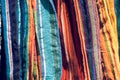 Abstract detail of a pile of colourful fabrics at a flea market