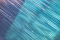 Abstract diagonal pattern of blue and turquoise transparent lines on textured glass surface Royalty Free Stock Photo