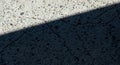 Abstract diagonal shadow across textured concrete surface with sunlight and dark contrast Royalty Free Stock Photo