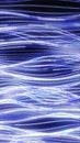 Abstract digital background of blue and white glowing dots forming smooth flowing wavy light trails Royalty Free Stock Photo