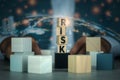 Abstract double exposure image of wooden cubes with risk word placed in front of businessman in suit.Rrisk management Royalty Free Stock Photo