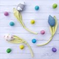 Abstract Easter background with painted wooden eggs and handmade tulip flowers on bleached wooden boards. Funny dotted abstract