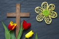 Abstract easter tulips and wooden cross on black marble Royalty Free Stock Photo