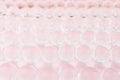 Abstract elegant gentle festive pink background with transparent glass balls, texture, blur. Royalty Free Stock Photo