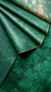 Abstract Emerald Green and Gold Textured Background with Elegant Material Fold