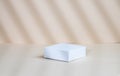 Abstract empty white box with shadows on a beige background. Layout concept for promotional product presentation, sale or