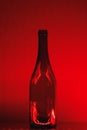 Abstract empty wine bottle with red led illumination Royalty Free Stock Photo