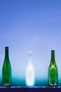 Abstract empty wine bottles with blue led illumination Royalty Free Stock Photo