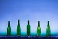 Abstract empty wine bottles with blue led illumination Royalty Free Stock Photo