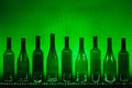 Abstract empty wine bottles with green led illumination Royalty Free Stock Photo