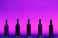 Abstract empty wine bottles with purple led illumination Royalty Free Stock Photo