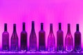 Abstract empty wine bottles with purple led illumination Royalty Free Stock Photo