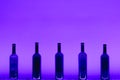 Abstract empty wine bottles with violet led illumination Royalty Free Stock Photo