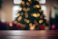 Abstract empty wooden desk table with copy space over christmas tree decorated blurred background Royalty Free Stock Photo