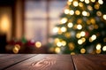 Abstract empty wooden desk table with copy space over christmas tree decorated blurred background Royalty Free Stock Photo