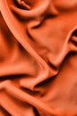 Abstract fabric texture. Trend shade of orange-red color. Top view