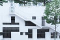 Abstract facade surrounded by trees, architectural background - grille windows different shapes and sizes