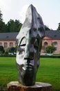 An abstract face sculpture against the bath house at Schwetzingen Palace and Gardens in Germany