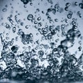 Abstract falling drops of water on a light background close-up Royalty Free Stock Photo