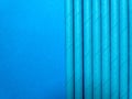 Blue paper tubes on a blue background