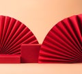 Abstract fashion podium for advertising cosmetics products. Red podium paper oriental fan pink pastel background