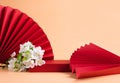 Abstract fashion podium for advertising cosmetics products. Red podium paper oriental fan pink pastel background