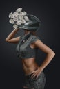 Abstract fashion portrait of young woman in motorcycle helmet with flowers