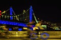 Abstract fast cyclist on a bridge background, city illumination, motion blur. Concept of modern lifestyle Royalty Free Stock Photo