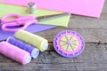 Abstract felt round flower with light pink beads. Handmade bright felt flower, scissors, thread, colorful felt sheets, thimble Royalty Free Stock Photo