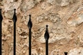 Abstract fence background with stone wall and metallic spears