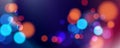 Abstract festive blurred background. Vibrant bokeh lights. Bright defocused glowing lights effect.