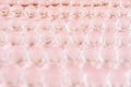 Abstract festive pastel pink cells background -  transparent glass spheres with gold glitter on soft light pink color, blur. Royalty Free Stock Photo