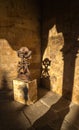Abstract figurative wrought iron sculpture illuminated by the evening sunlight casting its shadow forming a pareidolia cat figure