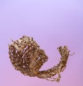 An abstract figure from a chopped corrugated cardboard on a gradient lilac-pink background Royalty Free Stock Photo