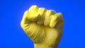 Abstract fist painted in the yellow color. Flag of Ukraine. Patriotic and togetherness concept. Concept of military conflict