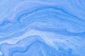 Abstract fluid art background light blue colors. Liquid marble. Acrylic painting on canvas with denim gradient