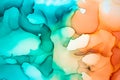 Abstract fluid art painting background in alcohol ink technique, mixture of turquoise and orange paints. Royalty Free Stock Photo