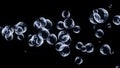 Abstract flying transparent blue bubbles on black background. Shallow depth of field. Soap bubbles flying on black Royalty Free Stock Photo