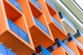 Abstract fragment of modern architecture, facade and orange balconies, close-up Royalty Free Stock Photo