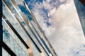 Abstract fragment of a modern building with glass facade for offices in Moscow. Sky and clouds reflected on the glass Royalty Free Stock Photo