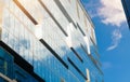 Abstract fragment of a modern building with glass facade for offices in Moscow. Sky and clouds reflected on the glass Royalty Free Stock Photo