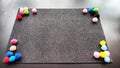 Abstract frame with a black velvet rectangle and multicolored balls. Background and texture with black color and colored Royalty Free Stock Photo