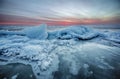 Abstract frozen winter sunrise seascape with ice and colored the sky. Royalty Free Stock Photo