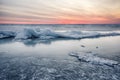 Abstract frozen winter sunrise seascape with ice and colored the sky. Royalty Free Stock Photo