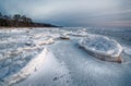 Abstract frozen winter sunrise seascape with ice and colored the sky. Royalty Free Stock Photo