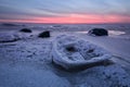 Abstract frozen winter sunrise seascape with ice and colored the sky. Royalty Free Stock Photo